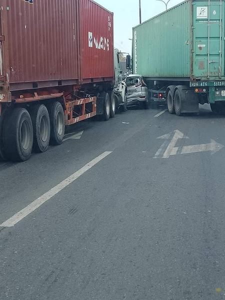 Ô tô Mitsubishi Xpander méo mó, biến dạng sau khi bị kẹp giữa 2 chiếc container tại Bình Tân